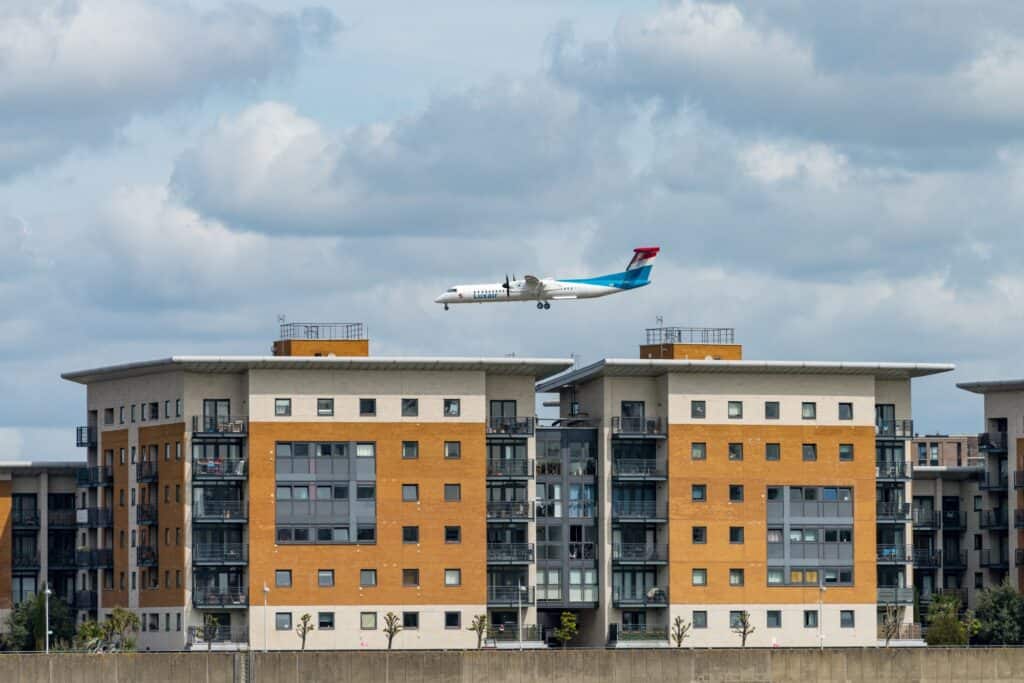 A plane over modern homes in Woolwich