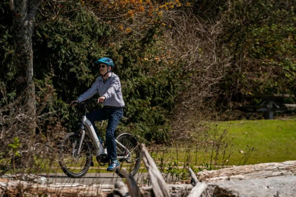 A man cycling in a park's trail